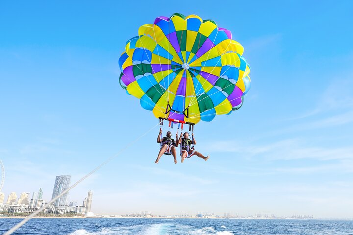 Soar above the stunning Dubai skyline taking in breathtaking views from over 250 meters high while enjoying an exhilarating parasailing adventure on the beach. Unforgettable memories await!